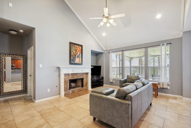 living area featuring ornamental molding, a fireplace, light tile patterned flooring, and baseboards