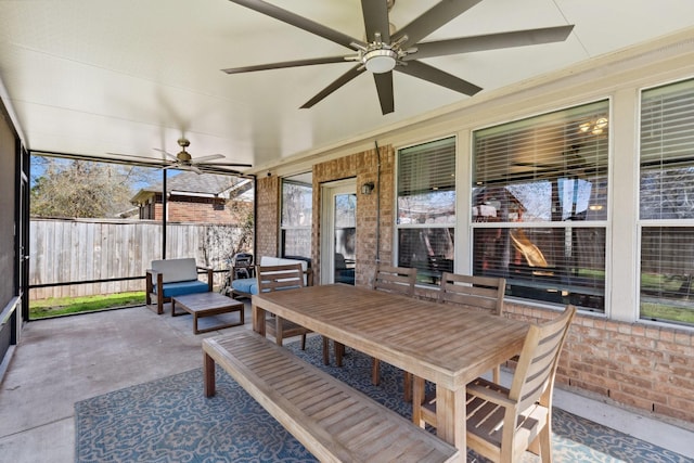 sunroom / solarium featuring a ceiling fan and a wealth of natural light