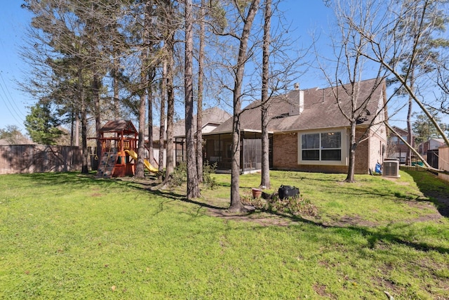 view of yard featuring cooling unit, a playground, and fence