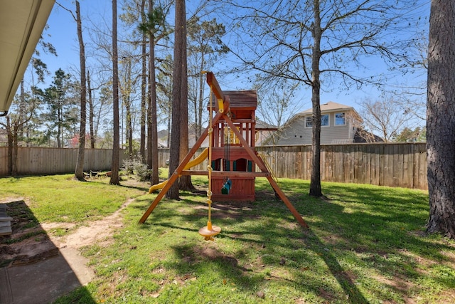 view of play area with a fenced backyard and a lawn