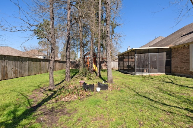 view of yard with a sunroom and a fenced backyard