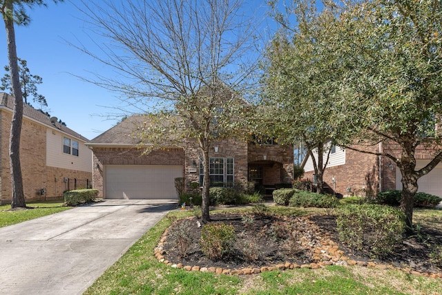 view of front of home with driveway, brick siding, and an attached garage