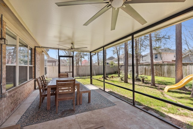 sunroom / solarium featuring a ceiling fan