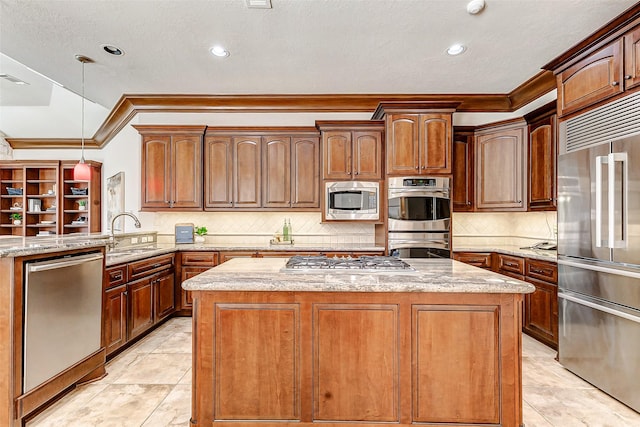 kitchen featuring crown molding, a center island, light stone countertops, and built in appliances