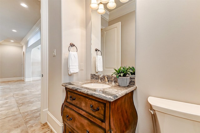 half bathroom featuring toilet, recessed lighting, vanity, baseboards, and ornamental molding