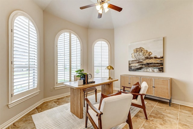 office featuring baseboards, vaulted ceiling, and a ceiling fan