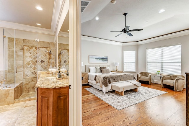 bedroom featuring light wood finished floors, visible vents, crown molding, and recessed lighting