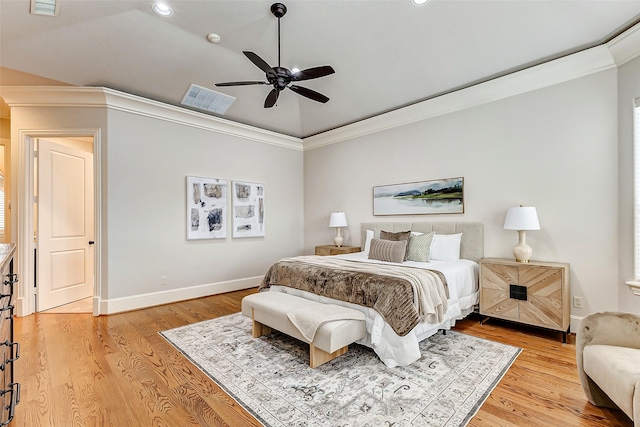 bedroom with light wood-type flooring, baseboards, visible vents, and ornamental molding