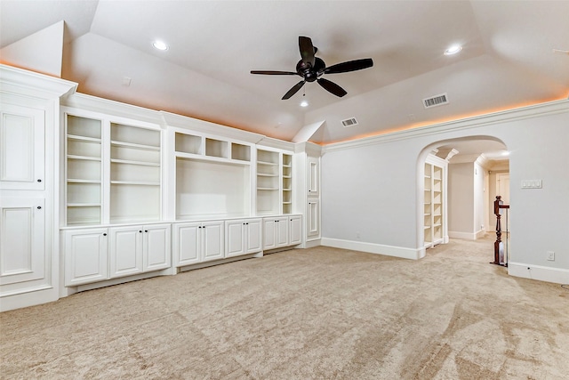 unfurnished living room with visible vents, arched walkways, light colored carpet, vaulted ceiling, and recessed lighting