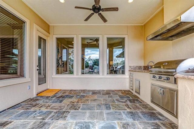 view of patio featuring exterior kitchen and a grill