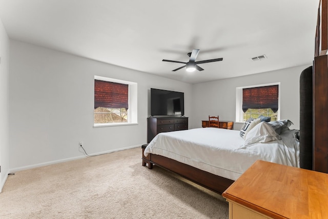 bedroom featuring ceiling fan, carpet flooring, visible vents, and baseboards