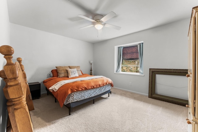 bedroom with ceiling fan, baseboards, and light colored carpet