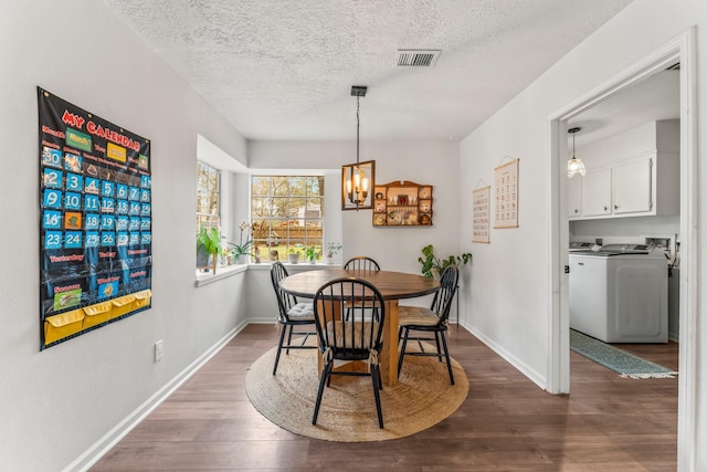 dining space featuring washer / dryer, baseboards, visible vents, dark wood finished floors, and a textured ceiling