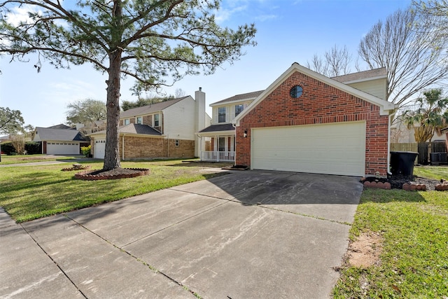 view of front of house with driveway, an attached garage, a front yard, and brick siding