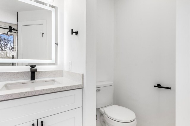 bathroom featuring toilet and vanity