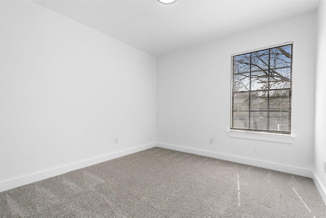 unfurnished room featuring baseboards and carpet flooring