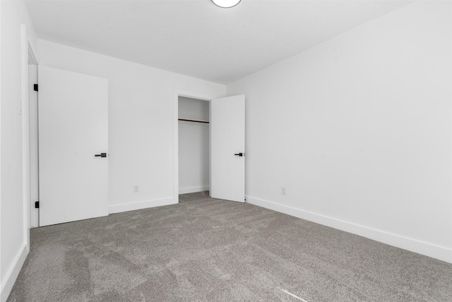 unfurnished bedroom featuring carpet floors, a closet, and baseboards