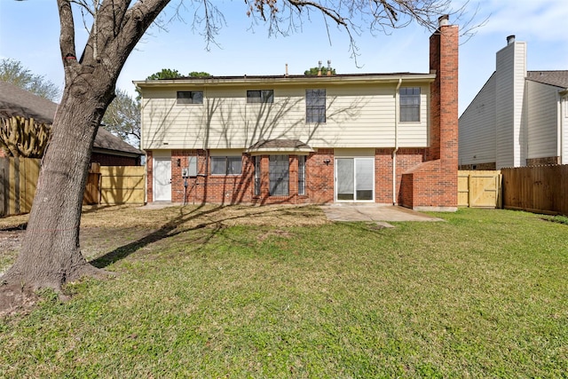 rear view of property featuring brick siding, a patio, a lawn, a gate, and fence