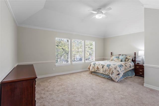 carpeted bedroom with crown molding, vaulted ceiling, baseboards, and ceiling fan