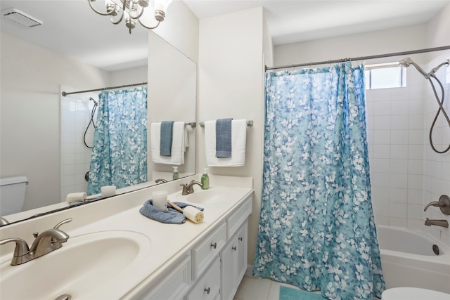 bathroom featuring visible vents, a sink, toilet, and shower / bath combo with shower curtain