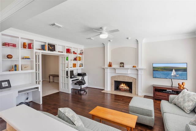 living room featuring a fireplace with flush hearth, visible vents, wood finished floors, and french doors