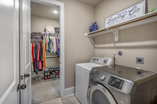 clothes washing area with carpet, laundry area, independent washer and dryer, and baseboards