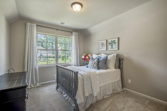 bedroom featuring lofted ceiling, carpet flooring, and baseboards