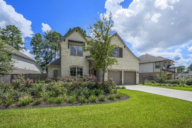 view of front of house with a garage, concrete driveway, stone siding, fence, and a front lawn