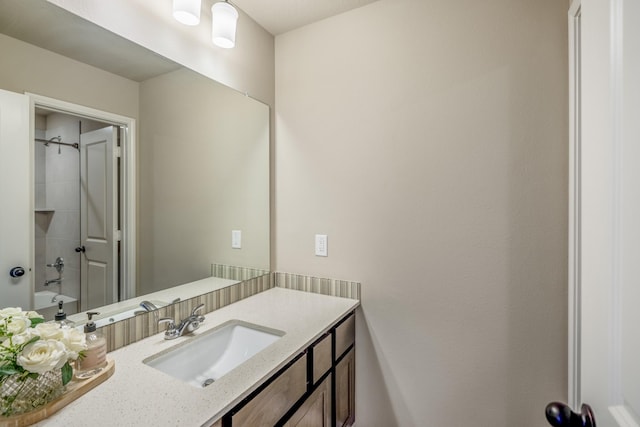 bathroom featuring shower / washtub combination and vanity