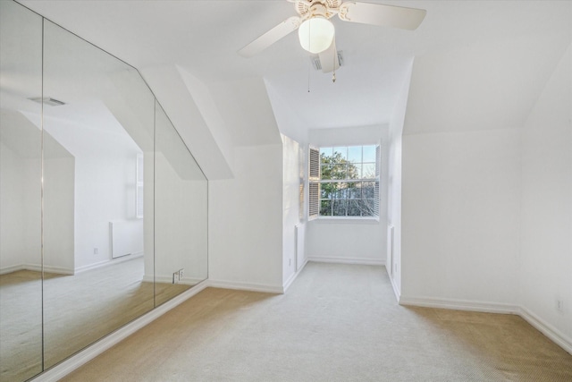 additional living space with visible vents, baseboards, lofted ceiling, and carpet floors