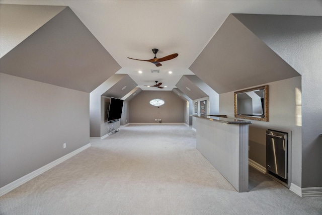 bonus room featuring visible vents, baseboards, light colored carpet, lofted ceiling, and a ceiling fan