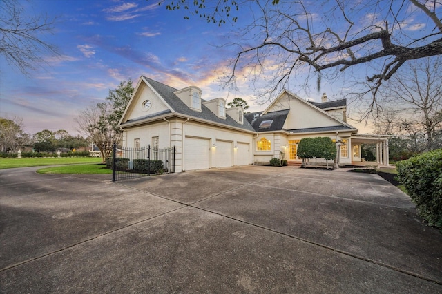 view of property exterior with driveway, a garage, and a gate