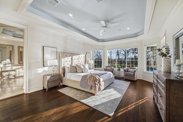 bedroom with a tray ceiling, baseboards, visible vents, and dark wood finished floors