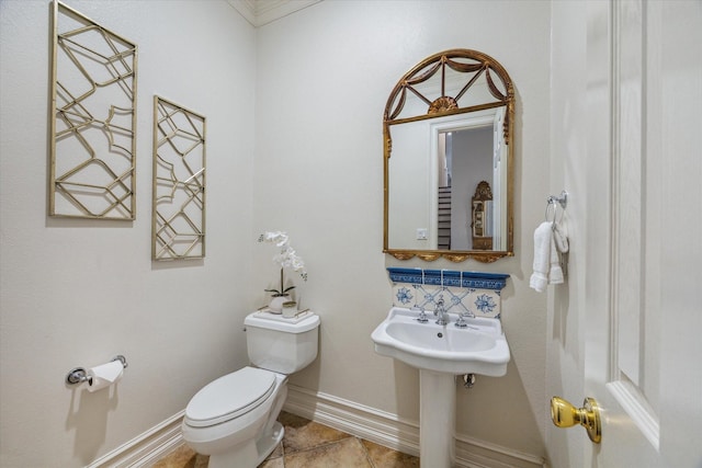 bathroom featuring tile patterned floors, baseboards, and toilet