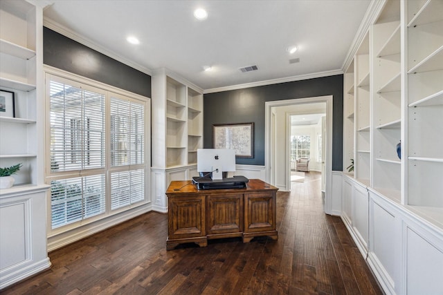 office area with visible vents, crown molding, built in features, wainscoting, and dark wood-style flooring