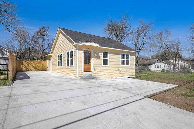 bungalow-style home featuring fence