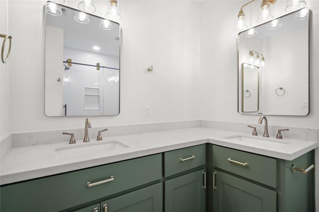 full bathroom with a sink, a tile shower, and double vanity