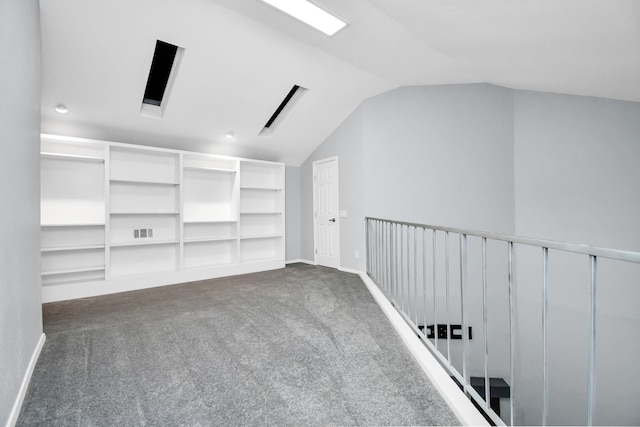 bonus room with vaulted ceiling, dark colored carpet, visible vents, and baseboards