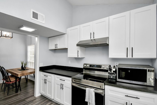 kitchen with stainless steel appliances, dark countertops, visible vents, and under cabinet range hood