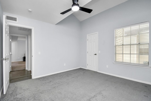 unfurnished room with lofted ceiling, ceiling fan, carpet flooring, visible vents, and baseboards