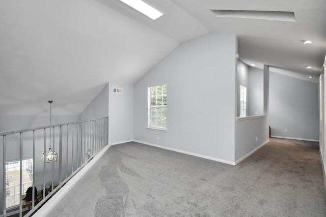 bonus room featuring carpet, vaulted ceiling, visible vents, and plenty of natural light