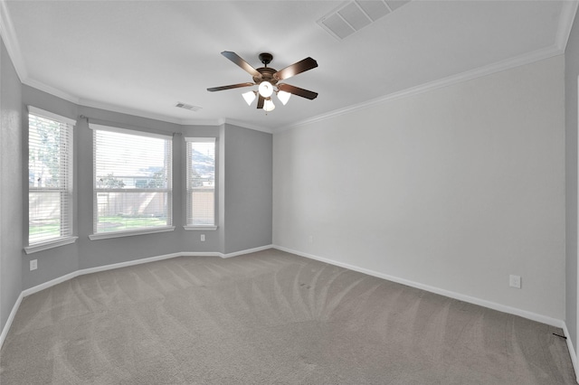 carpeted spare room featuring ornamental molding, visible vents, and baseboards