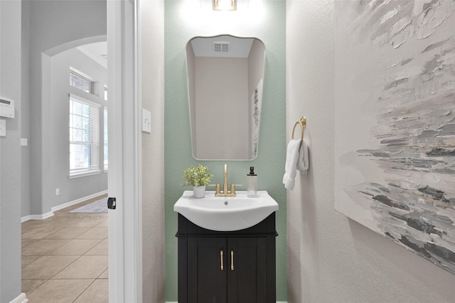 bathroom with vanity, tile patterned flooring, visible vents, and baseboards