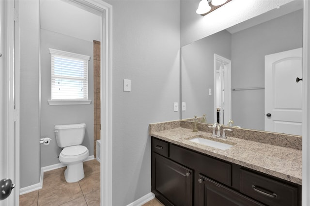 bathroom with toilet, tile patterned flooring, baseboards, and vanity