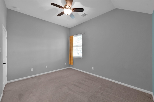 unfurnished room featuring visible vents, a ceiling fan, carpet flooring, vaulted ceiling, and baseboards