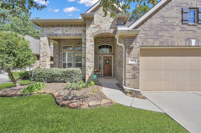 doorway to property featuring brick siding and an attached garage