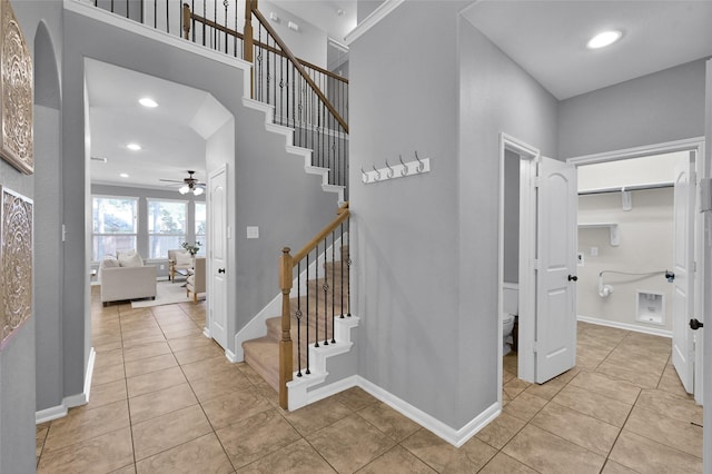 staircase featuring tile patterned flooring, baseboards, and recessed lighting