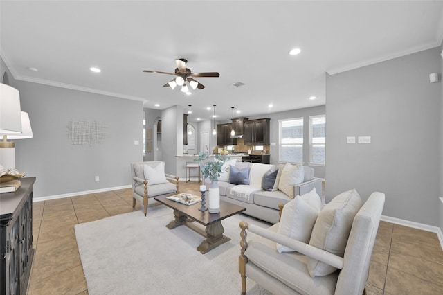 living area with crown molding, baseboards, and light tile patterned floors