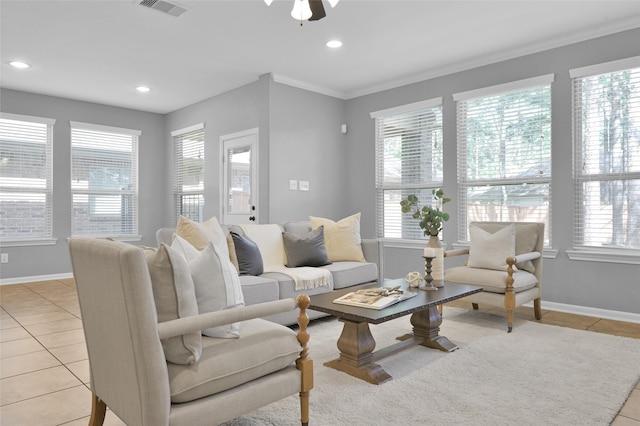 living area featuring a healthy amount of sunlight, light tile patterned floors, baseboards, and visible vents