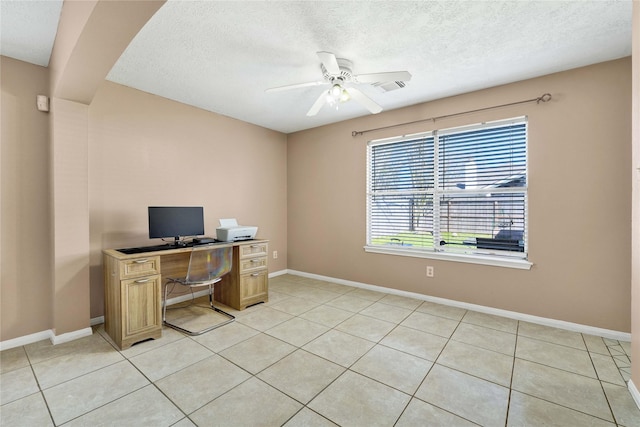 office with visible vents, light tile patterned flooring, ceiling fan, a textured ceiling, and baseboards